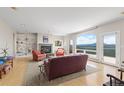 Bright living room with large arched windows offering amazing views, built-in shelves, and a cozy fireplace at 606 Sugarloaf Mountain Rd, Boulder, CO 80302