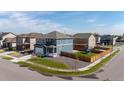 Aerial view of two-story home with fenced backyard and adjacent to playground and walking path at 902 William Way, Brighton, CO 80603