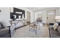 Open living area with stylish decor, including modern art and a patterned rug at 4022 E 17Th Avenue Pkwy, Denver, CO 80220
