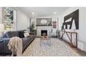 Bright living room featuring a fireplace, stylish rug, and comfortable seating at 4022 E 17Th Avenue Pkwy, Denver, CO 80220