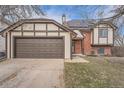 A home with a two-car garage and Tudor-style accents stands in a well-maintained neighborhood at 18251 E Union Dr, Aurora, CO 80015