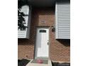 Close up of the front door with a new exterior light and well kept brick at 10630 Routt Way, Broomfield, CO 80021