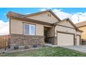 Attractive single-story home featuring a three-car garage, stone accents, and a well-maintained lawn at 13015 Tamarac Pl, Thornton, CO 80602