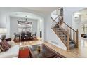 Inviting living room and dining area with hardwood floors, a staircase, and abundant natural light at 4027 Hawthorne Cir, Longmont, CO 80503