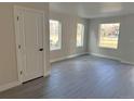Bright living room featuring large windows, modern floors, and neutral paint tones at 1652 N Lafayette St # 6, Denver, CO 80218