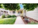 Inviting front porch with wooden columns and planter boxes, creating a warm welcome at 1750 Clark Dr, Erie, CO 80516