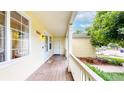 Cozy porch with natural wood floor and white railing, adorned with plants at 1750 Clark Dr, Erie, CO 80516