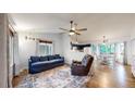 Comfortable living room featuring hardwood floors, blue sofa and a ceiling fan at 1750 Clark Dr, Erie, CO 80516