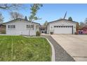 Charming single-Gathering home features a well-manicured lawn, attached garage and inviting curb appeal at 1025 Zang St, Golden, CO 80401