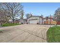Exterior view of attached two car garage and a well-maintained driveway at 1025 Zang St, Golden, CO 80401