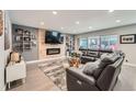 Spacious living room boasts a wooden accent wall with fireplace and glass sliding doors to the outdoor space at 1025 Zang St, Golden, CO 80401