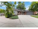 Well-maintained ranch-style home with an extended driveway, lush lawn and landscaping at 7440 Quail St, Arvada, CO 80005