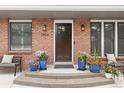 Close-up of front porch, potted plants, outdoor lanterns, and seating at 7440 Quail St, Arvada, CO 80005