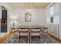 Elegant dining room featuring modern chandelier and large wooden table at 2333 Paint Pony Cir, Castle Rock, CO 80108