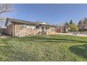 Attractive single-Gathering home featuring a well-kept lawn and inviting curb appeal at 3094 S Hobart Way, Denver, CO 80227