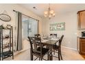 Cozy dining room featuring a chandelier, large window, and stylish decor at 13151 Grant N Cir # C, Thornton, CO 80241