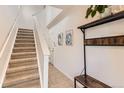 Inviting entryway with tile flooring, a coat rack, and stairs leading to the upper level at 13151 Grant N Cir # C, Thornton, CO 80241