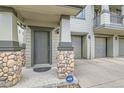 Charming front entry featuring stone accents, a modern door, and an ADT security system at 13151 Grant N Cir # C, Thornton, CO 80241