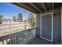 Covered back porch with a door leading to the yard, offering a cozy outdoor space at 1403 Valentia St, Denver, CO 80220