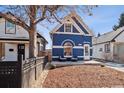 Charming blue home featuring a well-manicured front yard with outdoor seating and a welcoming facade at 1144 S Logan St, Denver, CO 80210