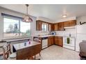 Bright kitchen featuring ample cabinet space and a breakfast nook at 7106 Reed Cir, Arvada, CO 80003