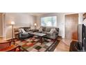 Comfortable living room with neutral tones, carpet, and a large window at 7106 Reed Cir, Arvada, CO 80003