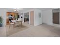 Bright dining area with stylish lighting, kitchen access and neutral tones offer a cozy atmosphere at 7507 Braun St, Arvada, CO 80005