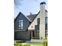 Charming two-story home showcasing a modern design, dark trim, and professional landscaping at 510 Glencoe St, Denver, CO 80220
