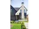 Stunning home with a two-tone exterior, landscaped yard, and distinctive architectural details at 510 Glencoe St, Denver, CO 80220