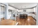 Spacious kitchen with white cabinets, stainless steel appliances, and a large center island, perfect for entertaining at 11584 Pine Canyon Ln, Parker, CO 80138