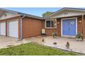 Welcoming front porch with a blue door, brick facade, and a cozy seating area at 865 S 8Th Ave, Brighton, CO 80601