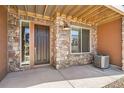 Close-up of front door showing stone facade and house number 9654 at 9654 Browns Peak Cir, Littleton, CO 80125