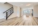 Open-concept living area featuring wood floors and staircase at 9654 Browns Peak Cir, Littleton, CO 80125