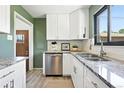 Modern kitchen featuring granite counters, white cabinets and stainless steel appliances at 2955 Poplar St, Denver, CO 80207