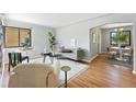Bright living room with hardwood floors, modern decor, and large window at 2955 Poplar St, Denver, CO 80207