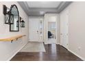 Inviting entryway with dark wood floors, a white door, and modern decorative accents at 8234 S Vandriver Way, Aurora, CO 80016
