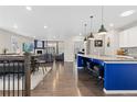 Open floor plan connecting a modern kitchen with an island to a cozy living room at 8234 S Vandriver Way, Aurora, CO 80016