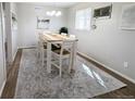 Dining room features a rustic wood table, stylish chairs, and modern decor at 992 Toledo St, Aurora, CO 80011