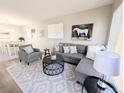 Bright living area boasts a comfortable sectional sofa, designer rug, and neutral paint at 992 Toledo St, Aurora, CO 80011