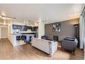 Open-concept living space with hardwood floors and combined kitchen-living area at 830 N Sherman St # 208, Denver, CO 80203