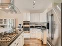 Modern kitchen features stainless steel appliances, granite countertops, and sleek white cabinetry at 30 Garfield St # B, Denver, CO 80206