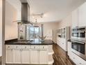 Open kitchen with granite counters, stainless appliances, and a breakfast bar that overlooks a cozy balcony at 30 Garfield St # B, Denver, CO 80206
