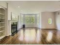 Bright living room boasts a fireplace, built-in shelving, and a wall of bay windows at 30 Garfield St # B, Denver, CO 80206