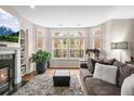 Bright living room with a fireplace, plush rug, large windows, and comfortable seating area at 30 Garfield St # B, Denver, CO 80206