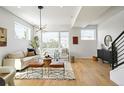 Spacious living room with light walls and a stylish chandelier at 4490 W 45Th Ave, Denver, CO 80212