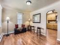 Inviting living room featuring wood floors, a window with blinds, and neutral wall color at 3265 S Ogden St, Englewood, CO 80113