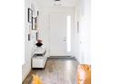 Bright foyer featuring hardwood floors, a stylish console table, and an artfully decorated gallery wall at 2321 S Acoma St, Denver, CO 80223