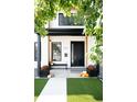 Charming front porch with decorative pumpkins, flower boxes, and seating, offering a welcoming entrance at 2321 S Acoma St, Denver, CO 80223