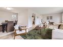 Open-concept living room with stylish furniture and easy access to dining area at 10712 Larson Dr, Northglenn, CO 80233