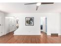 Spacious, brightly lit living room with hardwood floors, ceiling fan, and white walls at 2336 S Dawson Way, Aurora, CO 80014